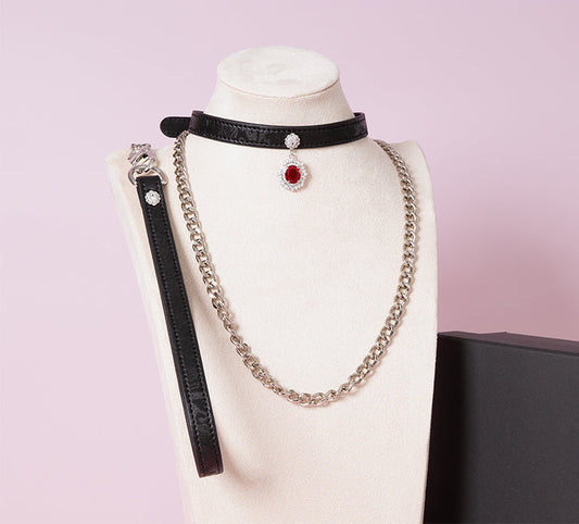 Black leather choker featuring a silver and red jewelled pendant in the centre, with a silver chain leash - handmade in the UK for gothic fashion