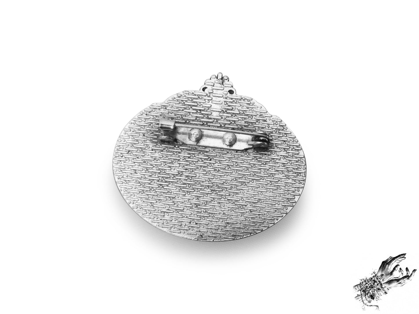 Rear view photo of the antique silver and red bat cameo brooch, showing the silver brooch pin securely fastened at the top of the ornate frame, inspired by Victorian gothic fashion