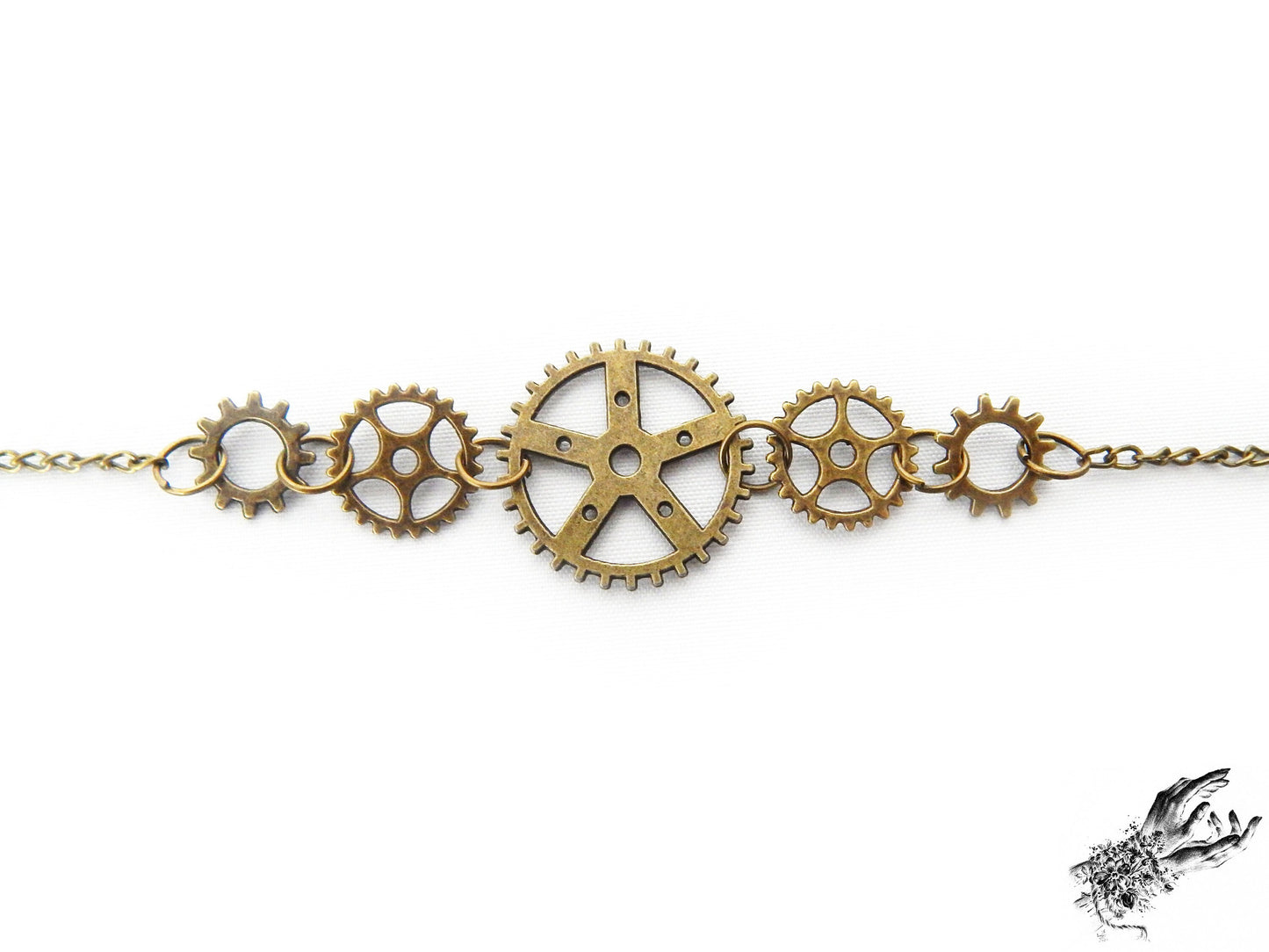 Close-up of the antique bronze gear bracelet, showing the intricate silver clockwork charms, a perfect gift for Steampunk fashion in the UK