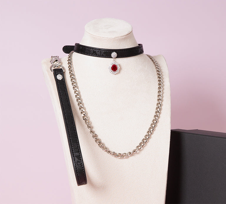 Black leather choker featuring a silver and red jewelled pendant in the centre, with a silver chain leash - handmade in the UK for gothic fashion