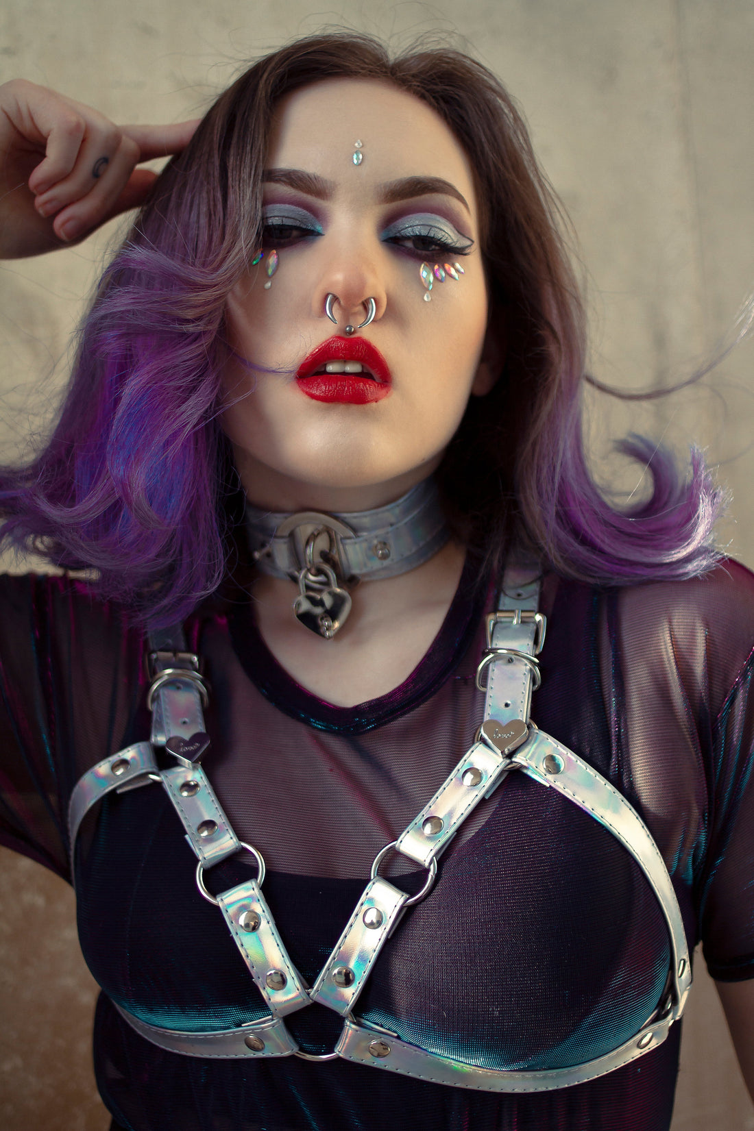 alternative girl wearing a holographic silver cage harness bra by 8th Sin with a matching choker and crystal make-up