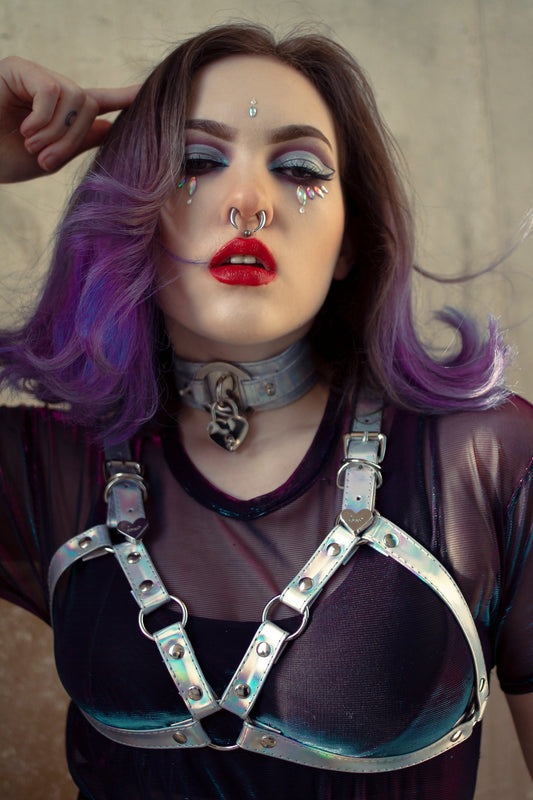 alternative girl wearing a holographic silver cage harness bra by 8th Sin with a matching choker and crystal make-up