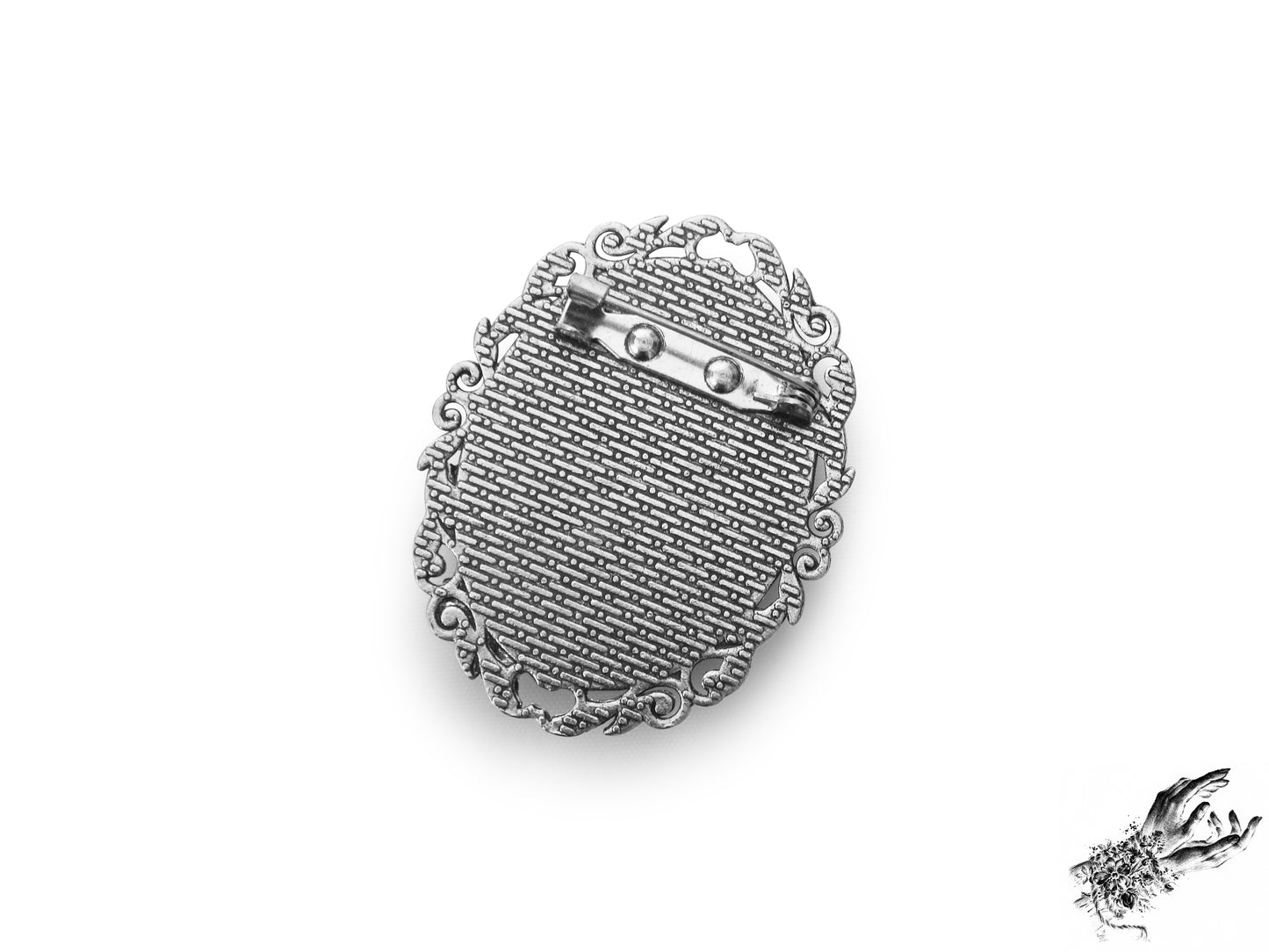 Rear view photo of the antique silver and ivory beetle cameo brooch, showing the silver brooch pin securely fastened at the top of the ornate frame, inspired by Victorian gothic fashion