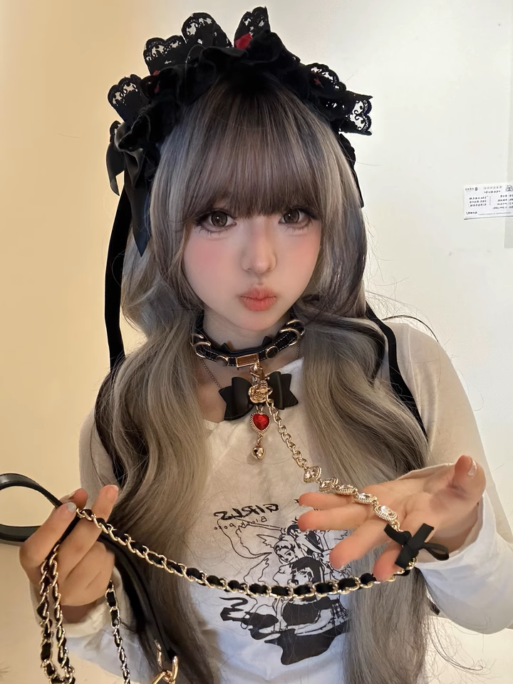 Customer photo of the black and gold choker set, showing the detchable bow charm and chain leash clipped to the choker, styled with a black lace headdress for a kawaii fashion aesthetic