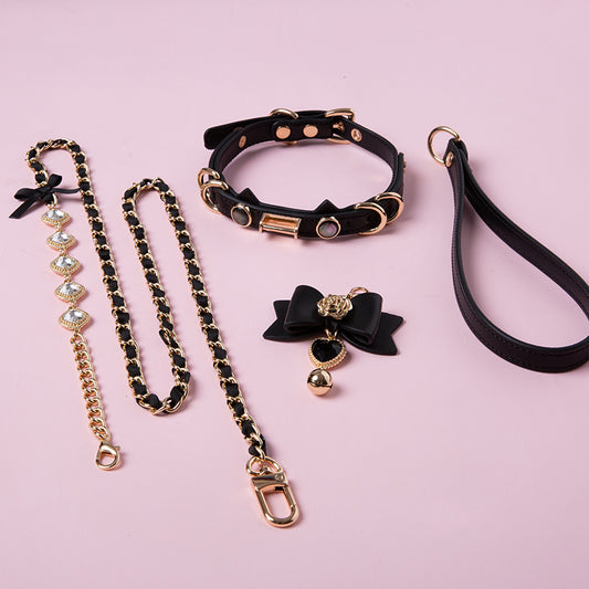Black and gold choker set featuring a leather cat pendant choker, black and gold diamante chain leash, black leather hand strap and cute detachable bow charm
