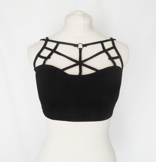 Black strappy tube top featuring geometric criss-cross straps on the chest, displayed on a white mannequin torso against a white background.