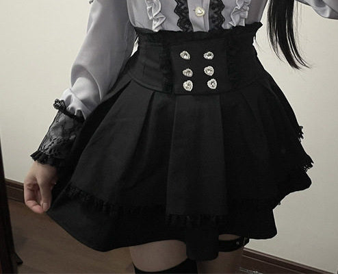 Black high waisted skirt featuring a ruffled waist, diamante heart shaped buttons, pleated a-line design and lace trimmed hem, styled with a grey and black lace blouse for a Jirai Kei aesthetic.