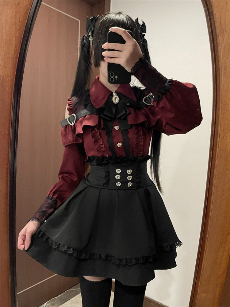 Black high waisted skirt featuring a ruffled waist, diamante heart shaped buttons, pleated a-line design and lace trimmed hem, styled with a red and black lace blouse for a Jirai Kei aesthetic.