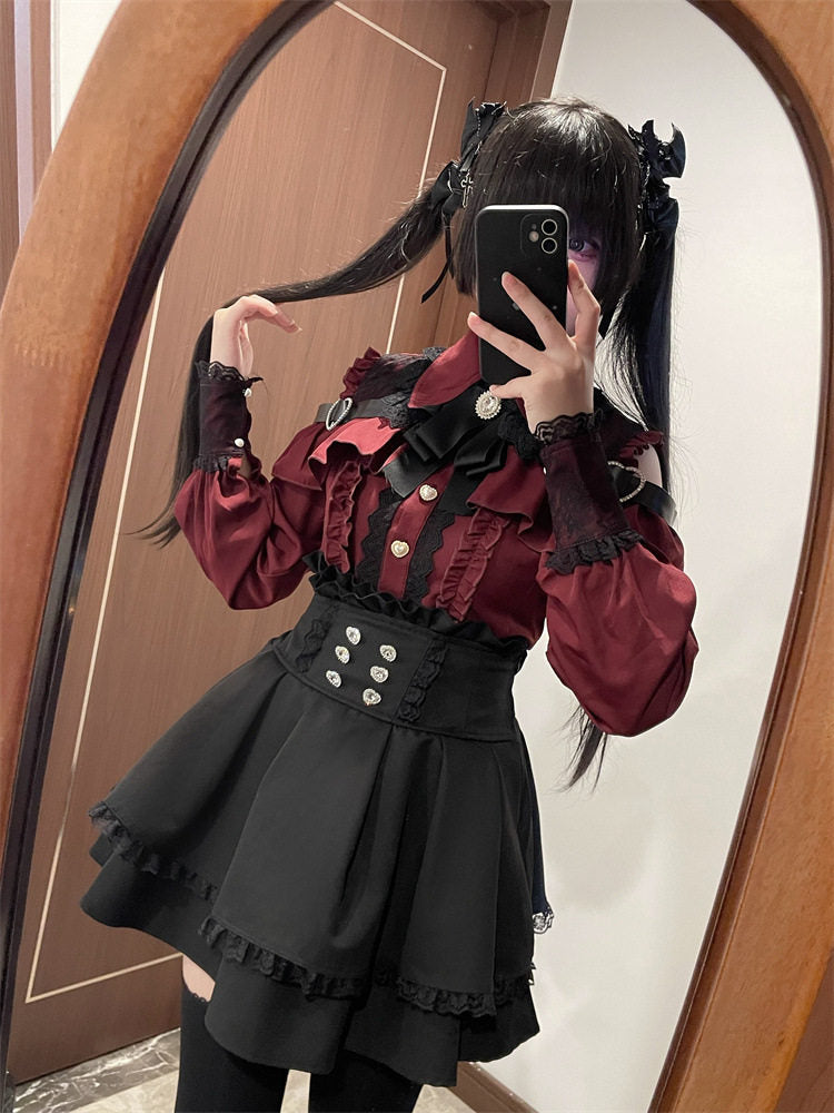 A person taking a mirror selfie wearing a gothic Lolita-style outfit consisting of a dark red ruffled blouse with silver buttons, a black corset-style waist belt with silver buttons, and a black pleated skirt with ruffled trim.