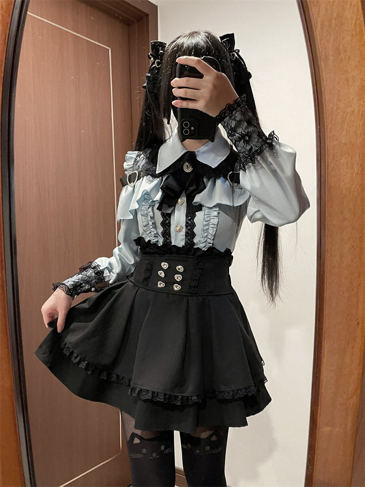 Black high waisted skirt featuring a ruffled waist, diamante heart shaped buttons, pleated a-line design and lace trimmed hem, styled with a blue and black lace blouse for a Jirai Kei aesthetic.