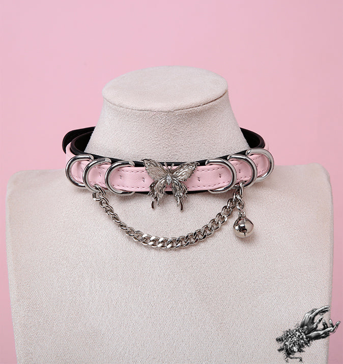 Black and pink leather choker featuring a ornate silver butterfly pendant, chunky chain and a dainty silver bell, worn on a mannequin bust