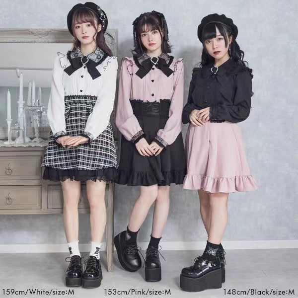 Three models wearing Jirai Kei style outfits with long-sleeved blouses and pleated skirts, standing in front of a gray wall with a wooden cabinet in the background. Text at the bottom shows measurements for white, pink, and black sizes.