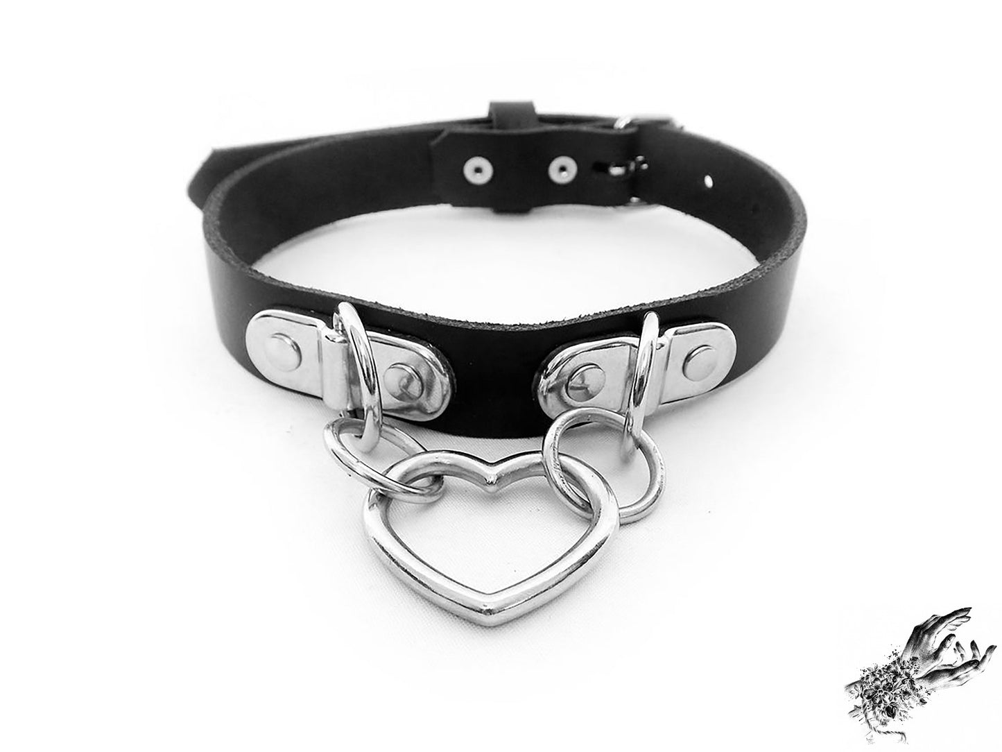 Black leather choker with a silver heart-shaped pendant on a white background