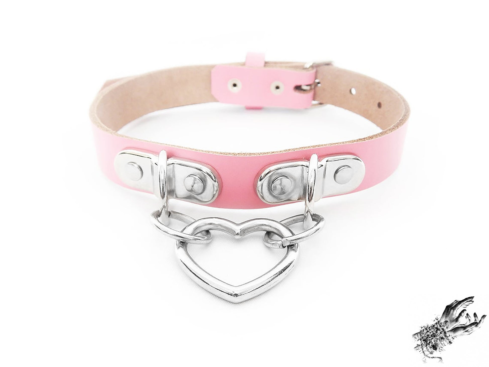 Pink leather collar with a silver heart-shaped pendant on a white background