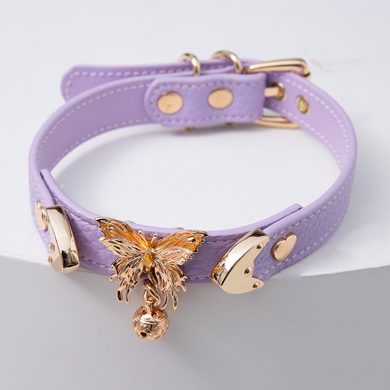 Lilac leather choker featuring ornate gold butterfly and bell hardware and an adjustable gold tone buckle at the back, designed for fairy kei and Harajuku fashion in the UK