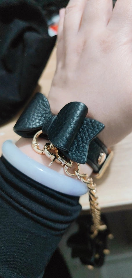 Customer photo of black and gold bow wristband, made with real leather and gold tone hardware