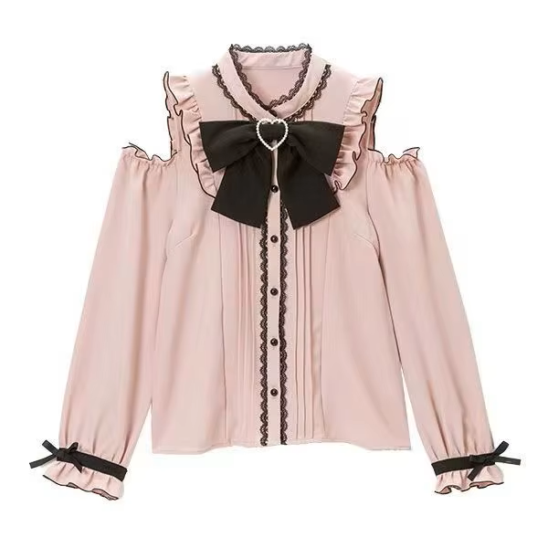Pink and black polyester blouse featuring cold shoulder cut-outs, lace trimmed collar and button placket, pintucks, black pearlescent buttons and detachable ribbon bow tie, displayed on a mannequin against a white background.