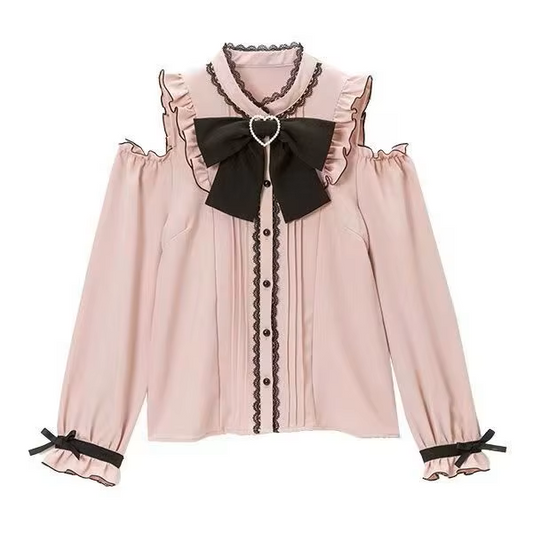 Pink and black polyester blouse featuring cold shoulder cut-outs, lace trimmed collar and button placket, pintucks, black pearlescent buttons and detachable ribbon bow tie, displayed on a mannequin against a white background.