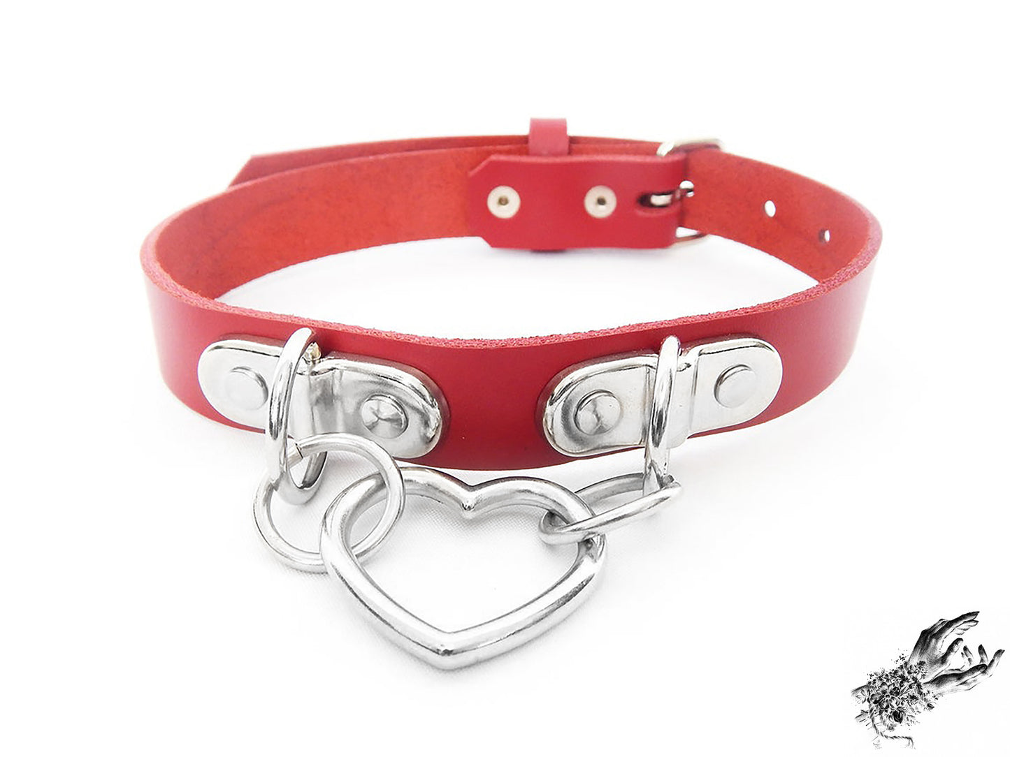 Red leather choker with a silver heart-shaped pendant on a white background
