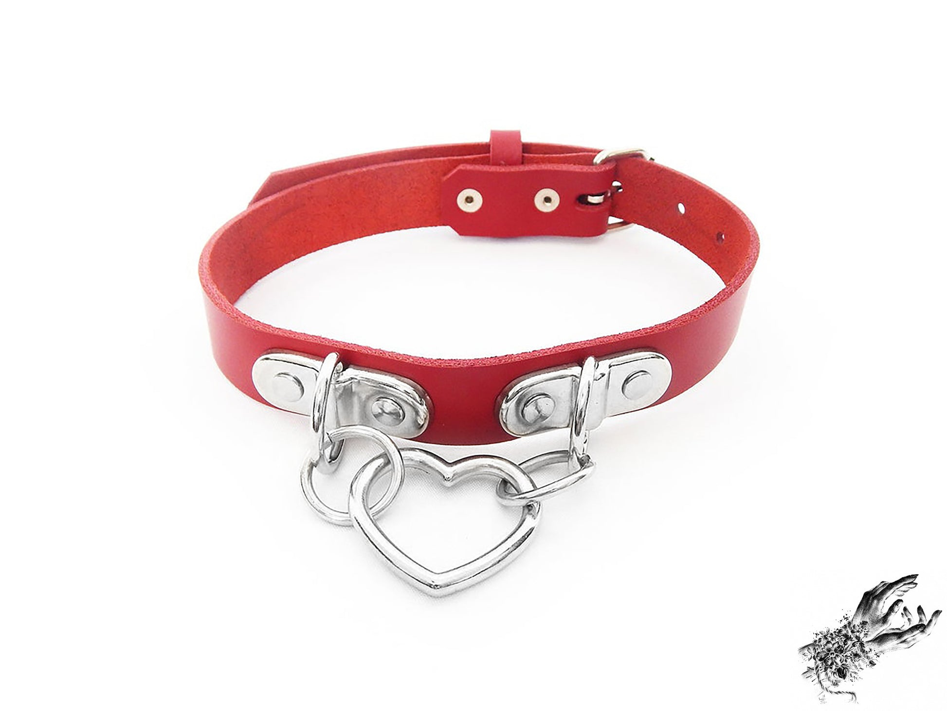 Red leather choker with a silver heart-shaped pendant on a white background