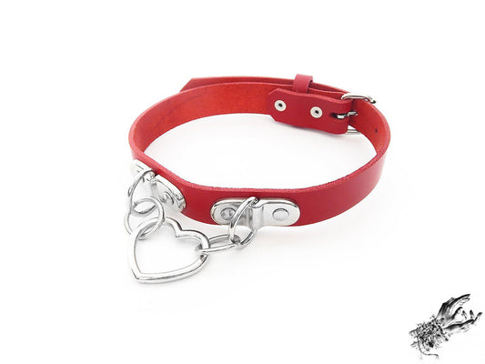 Red leather choker with a silver heart-shaped pendant on a white background