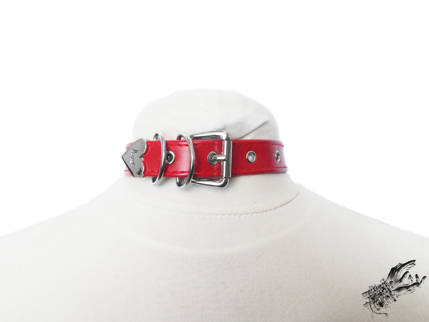 Rear view of a red faux leather choker showing the stainless steel plated buckle fastening and multiple sizing holes at the back. Displayed on a white mannequin bust against a white background.