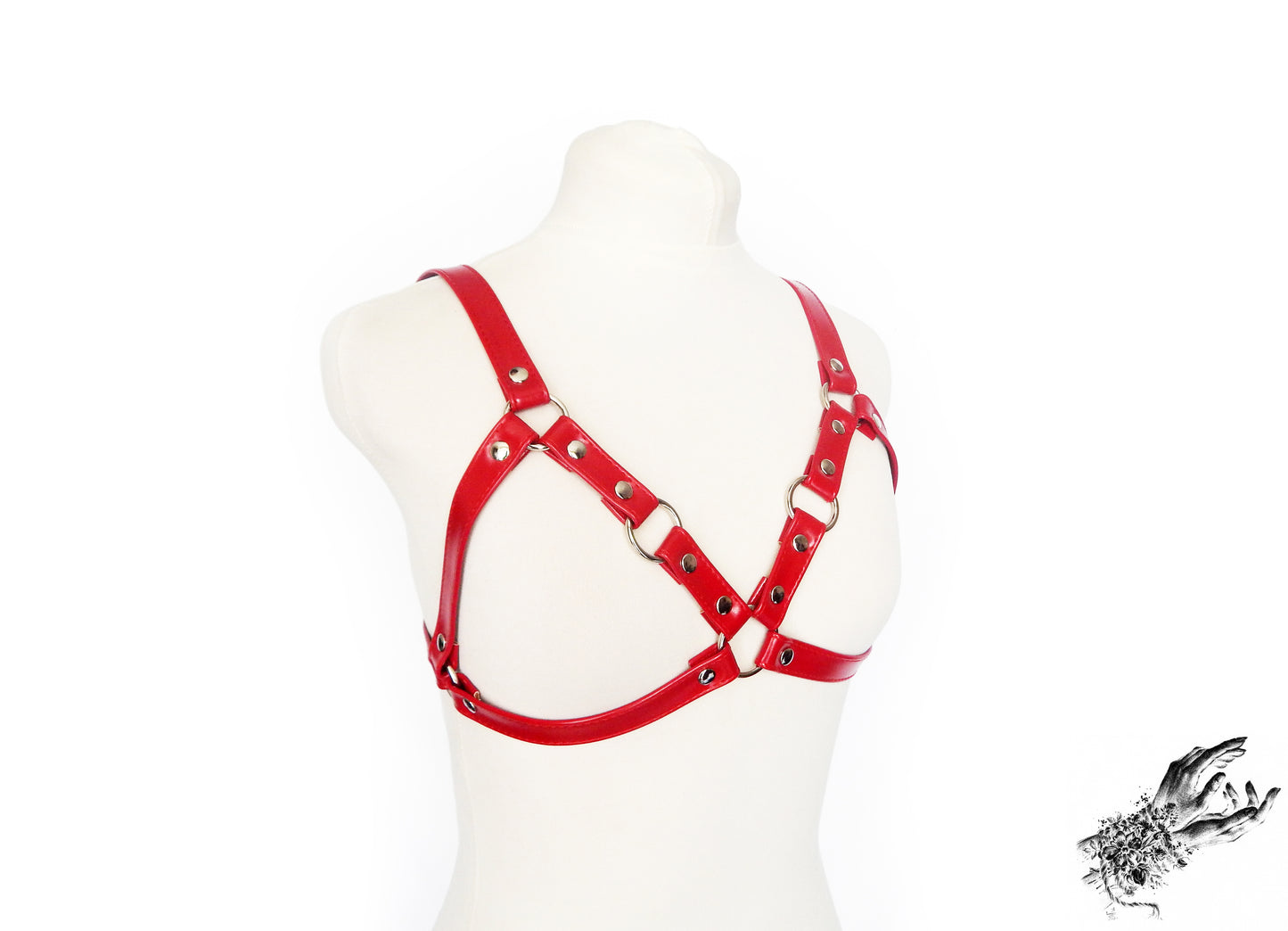 Red faux leather harness bra featuring a cage bra design, silver O ring hardware with adjustable shoulder and back straps, displayed on a mannequin against a white background.
