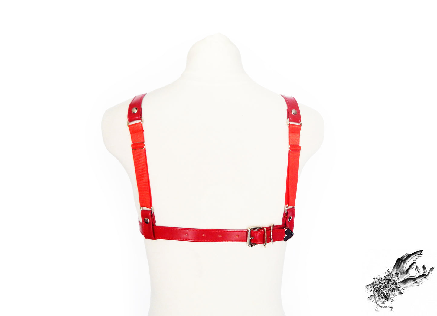 Rear view of a red faux leather harness bra showing the adjustable elastic shoulder straps and buckled faux leather back strap, displayed on a mannequin against a white background.