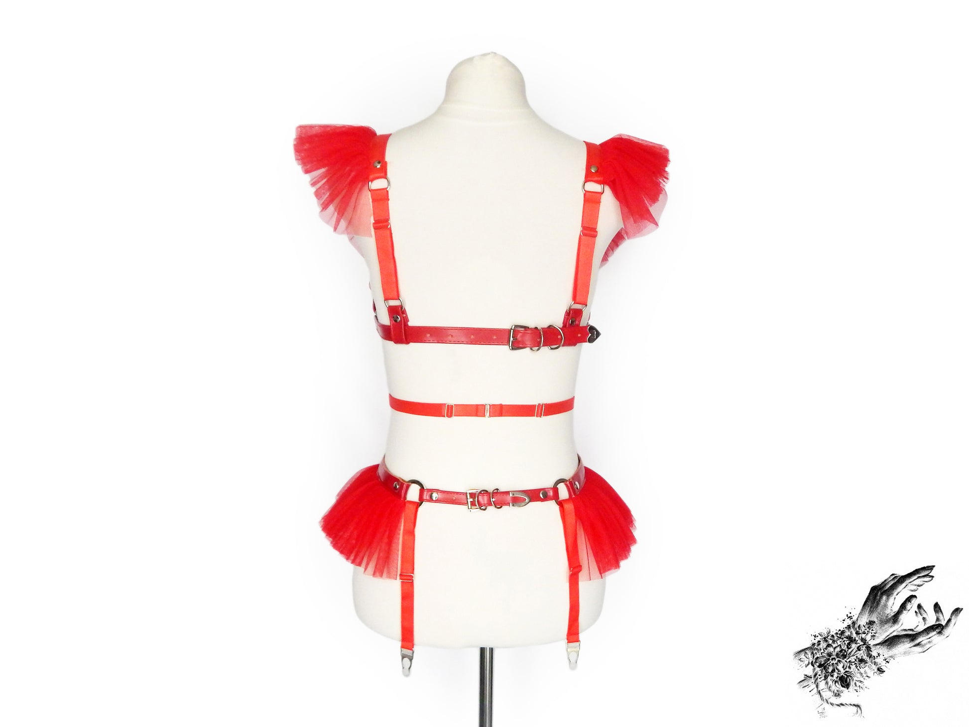 Rear view of a red vegan leather harness set featuring a separate harness bra and garter belt, showing the adjustable elastic and faux leather straps, displayed on a mannequin against a white background.