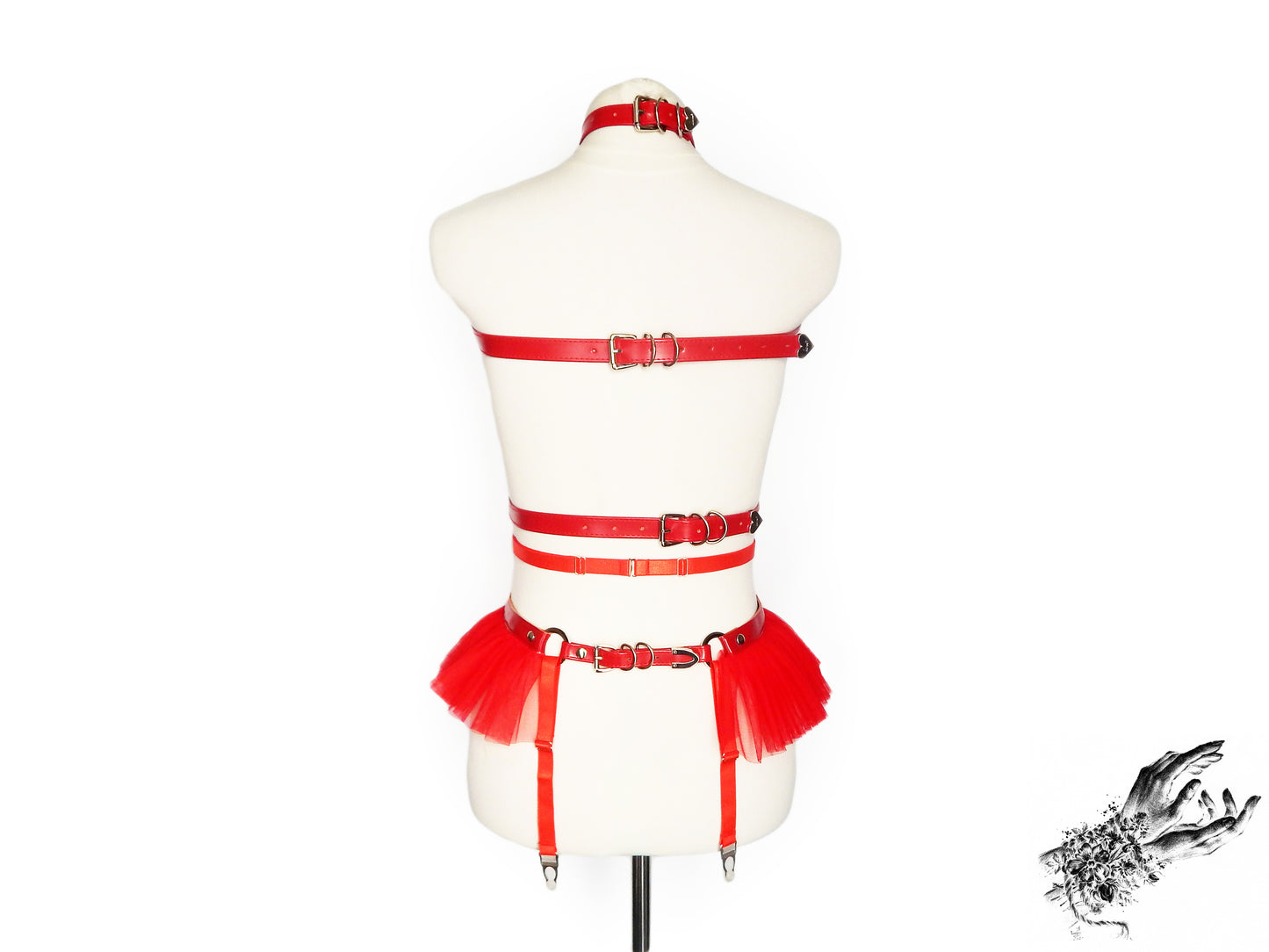 Rear view of a red vegan leather harness set showing the adjustable elastic waist and suspender straps and buckled faux leather back straps, displayed on a mannequin against a white background.
