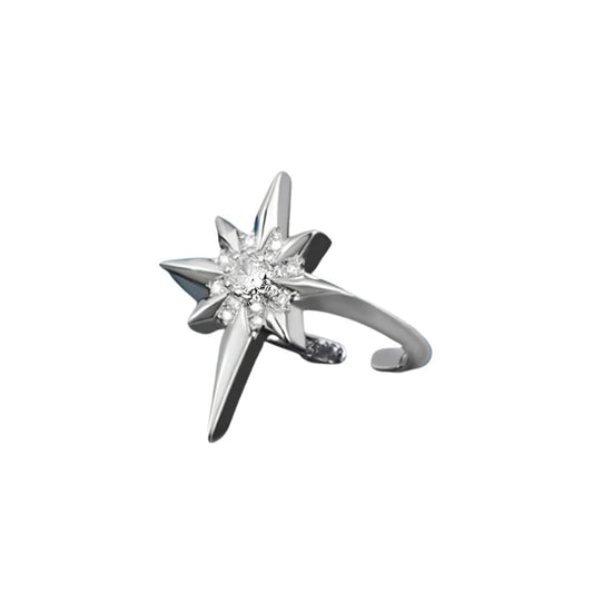 A silver-toned starburst ring with a clear central gemstone, shown on a plain white background.