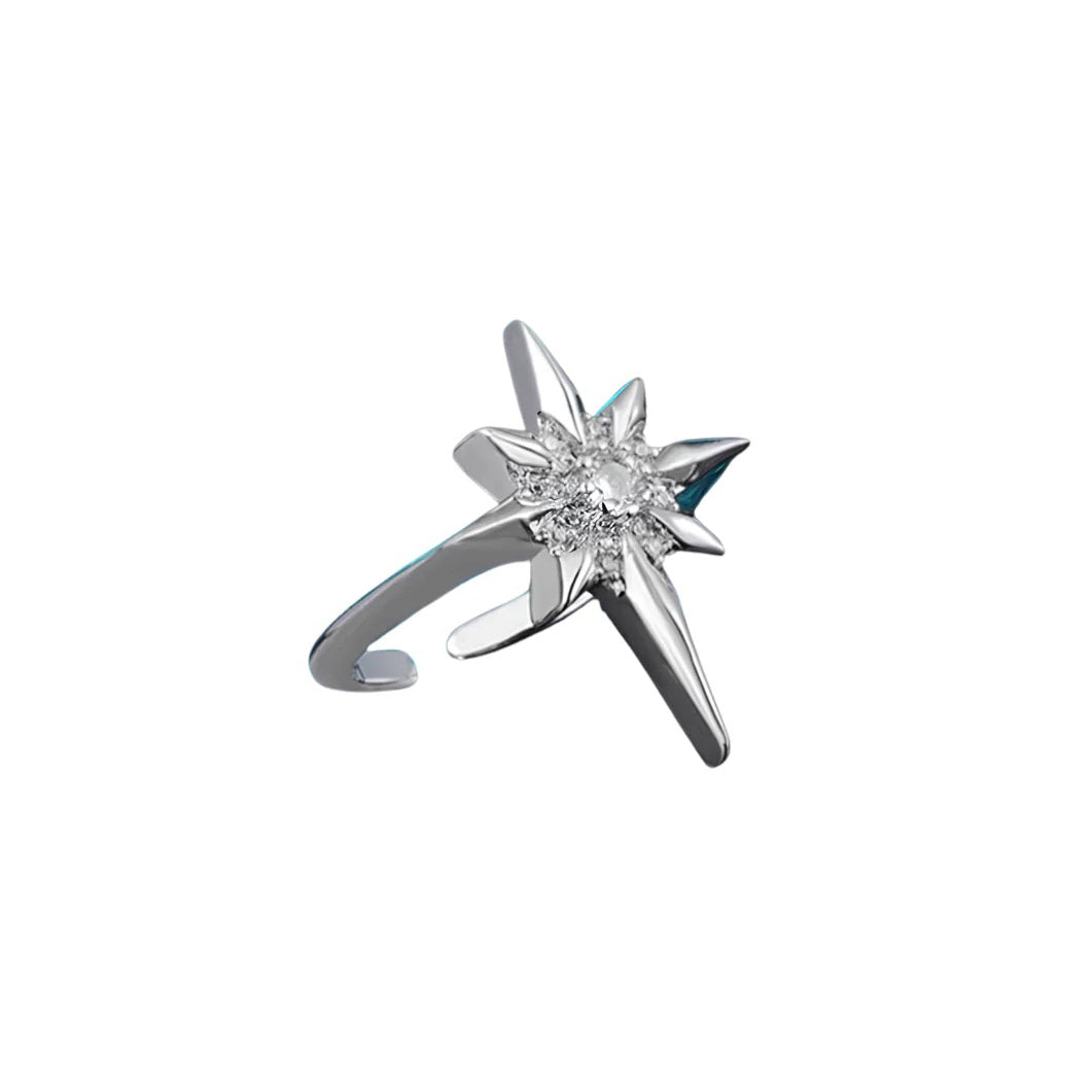 A silver-toned starburst ring featuring a central cluster of clear zircon gemstones and an adjustable band, shown on a plain white background.