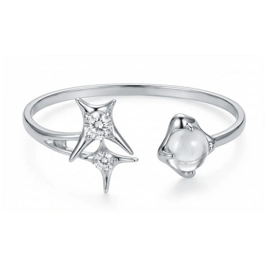 A silver plated costume jewellery bangle featuring a silver starburst design, wrap-around cuff and clear round glass crystal gemstones, displayed on a white background.