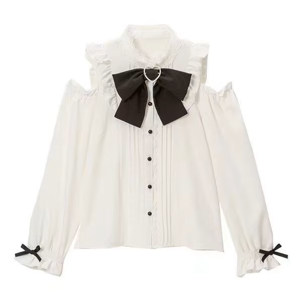 White and black polyester blouse featuring cold shoulder cut-outs, lace trimmed collar and button placket, pintucks, black pearlescent buttons and detachable ribbon bow tie, displayed on a mannequin against a white background.