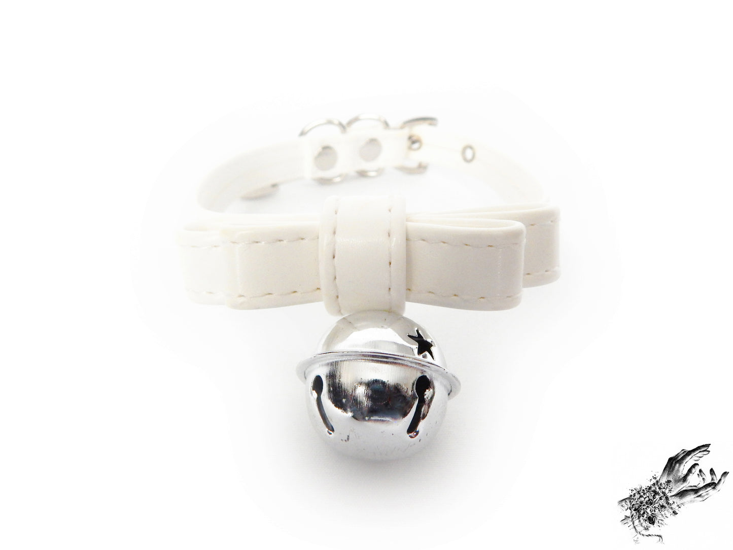 Close-up of a white faux leather bow choker featuring a silver bell design, with adjustable buckle at the back