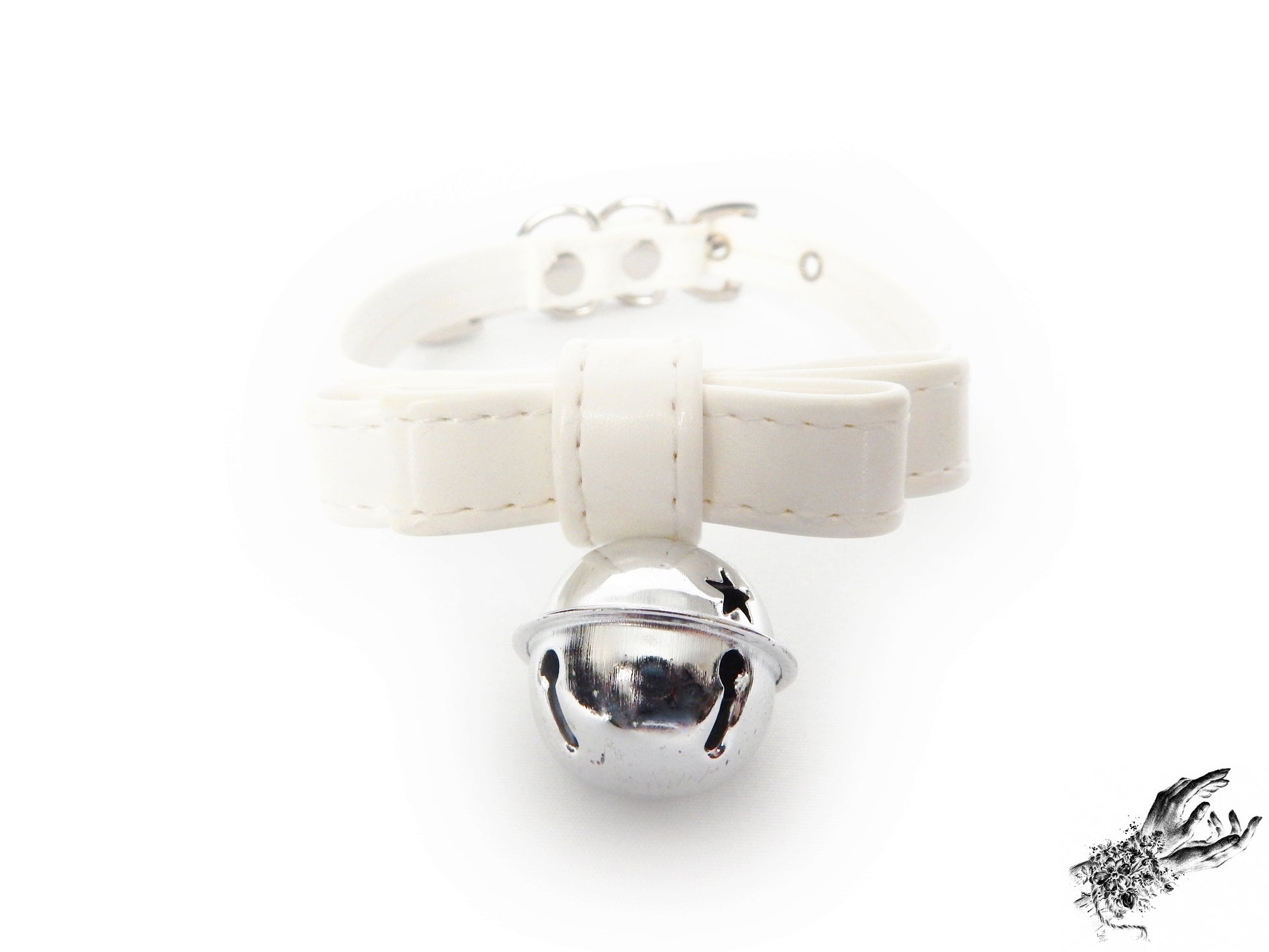 Close-up of a white faux leather bow choker featuring a silver bell design, with adjustable buckle at the back