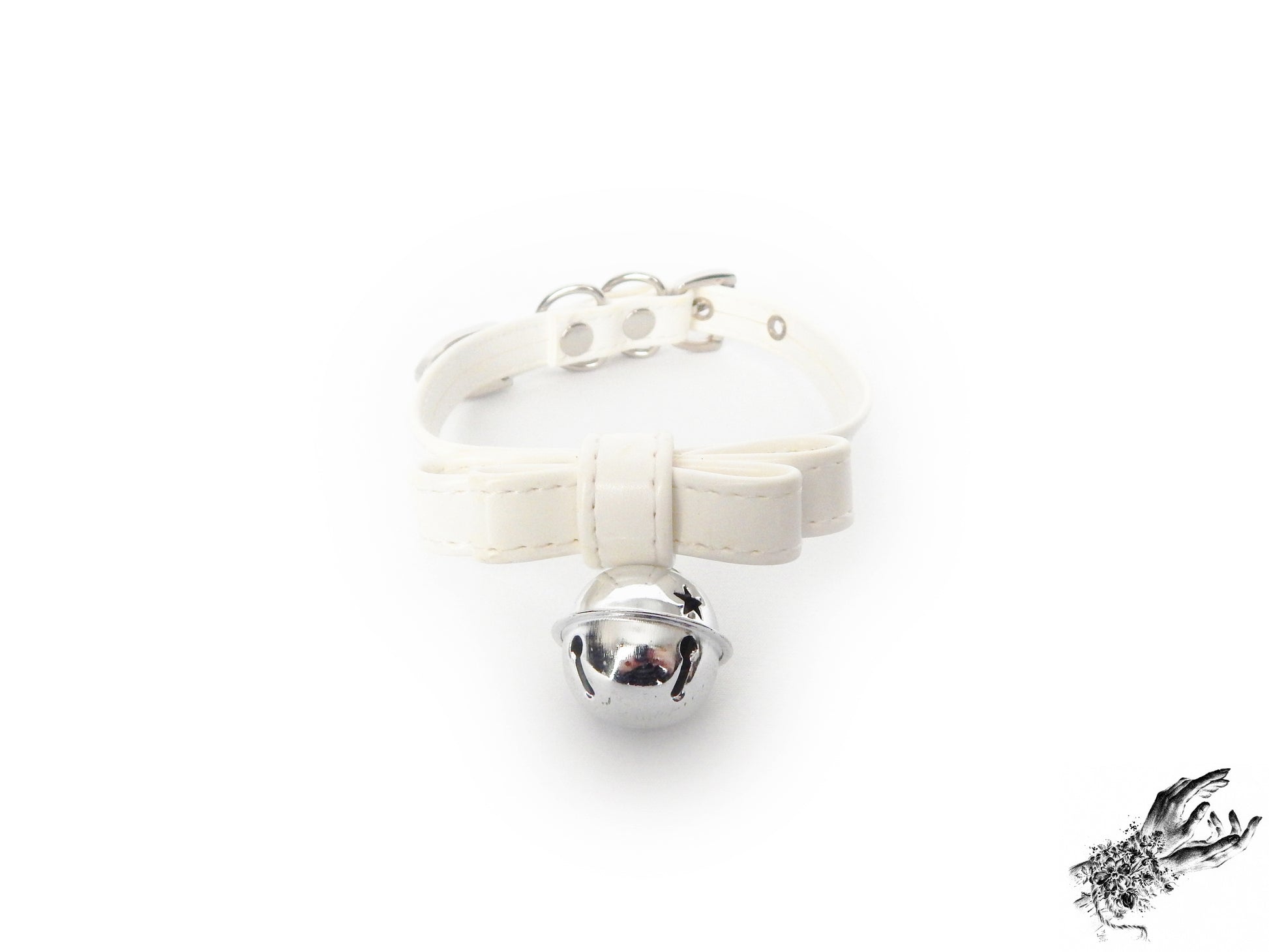 White faux leather bow choker featuring a silver bell design, with adjustable buckle at the back