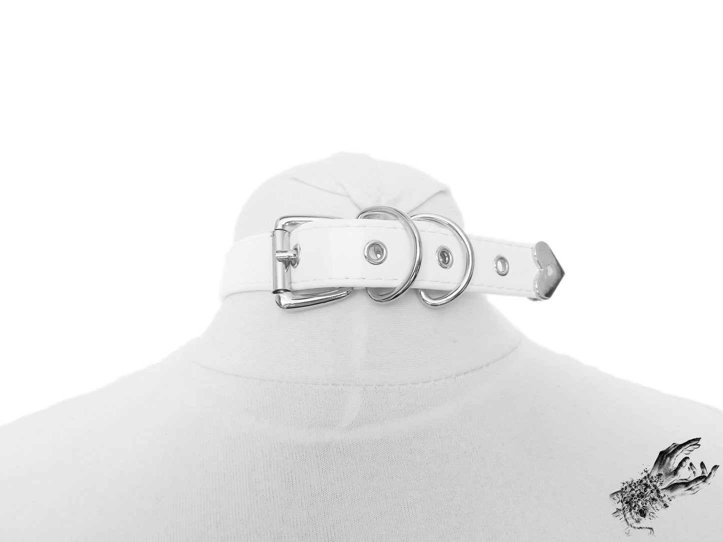 Rear view of a white faux leather choker featuring a stainless steel plated buckle and sizing holes at the back. Displayed on a cream mannequin bust against a white background.