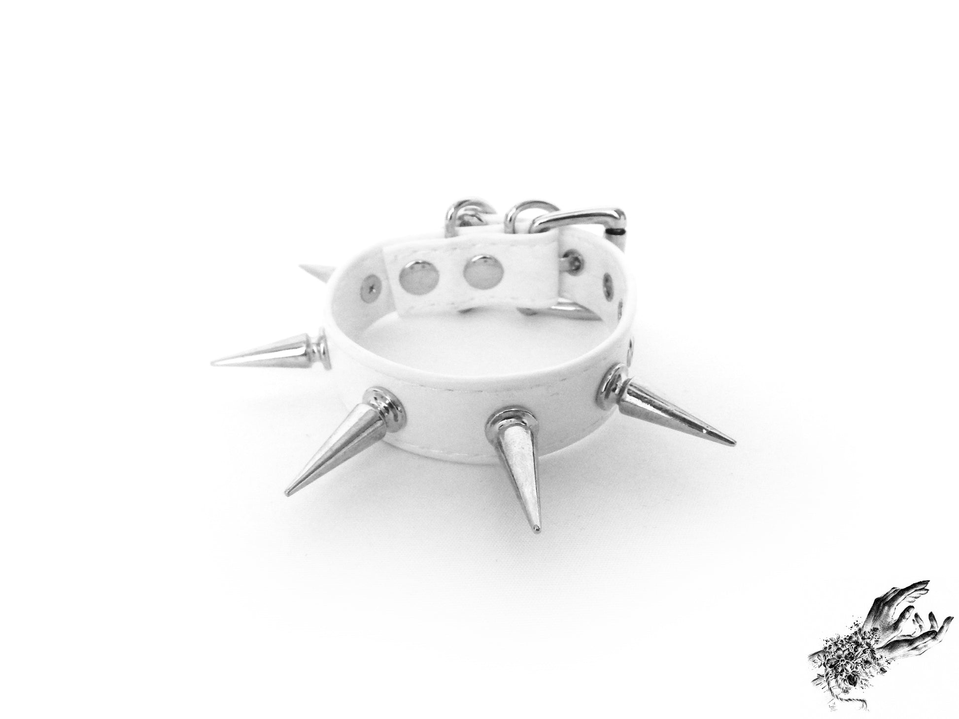 White faux leather wristband featuring bold silver 25mm spike studs and adjustable buckle