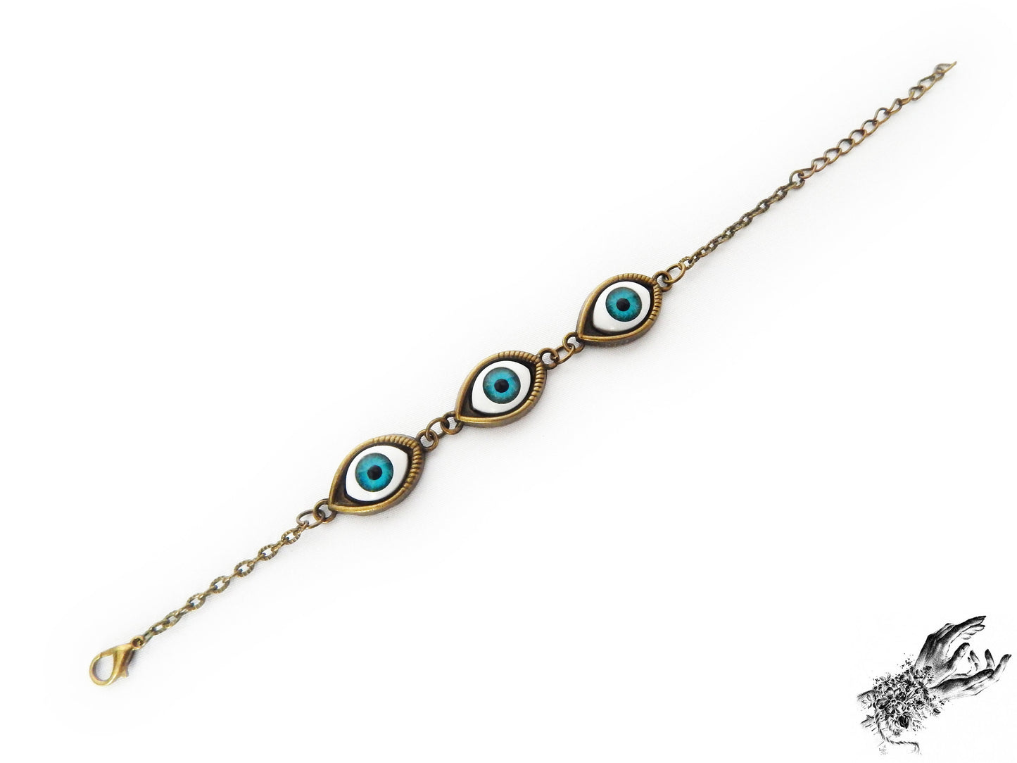 Vintage style antique bronze evil eye bracelet with bright blue irises displayed on a white background