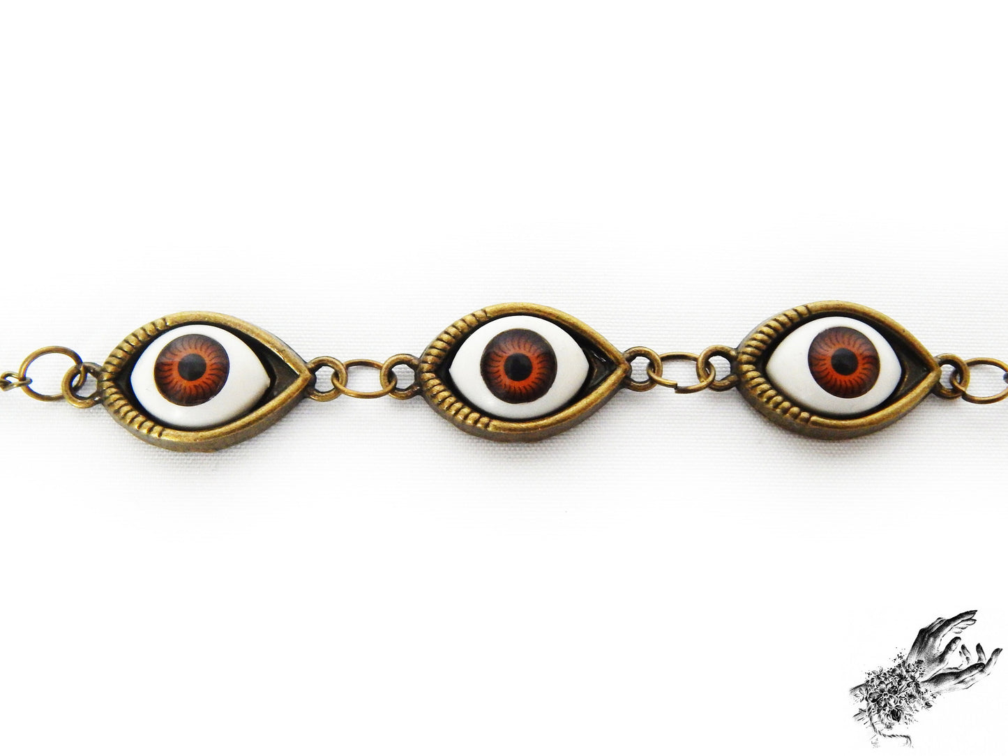 Close-up photo of the antique bronze evil eye bracelet, showing the rich brown iris colour in bronze cameo frames, creating a vintage inspired aesthetic