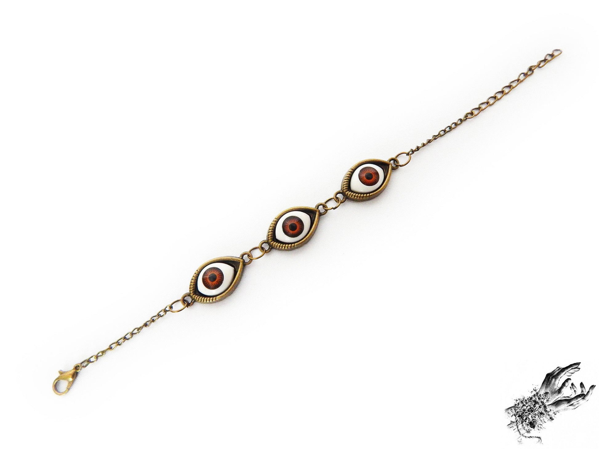 Vintage inspired antique bronze evil eye bracelet showing the rich brown irises in bronze cameo frames