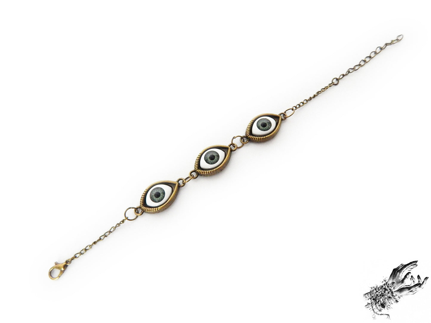 Antique bronze evil eye bracelet featuring striking green irises in bronze cameo frames for a vintage fashion aesthetic