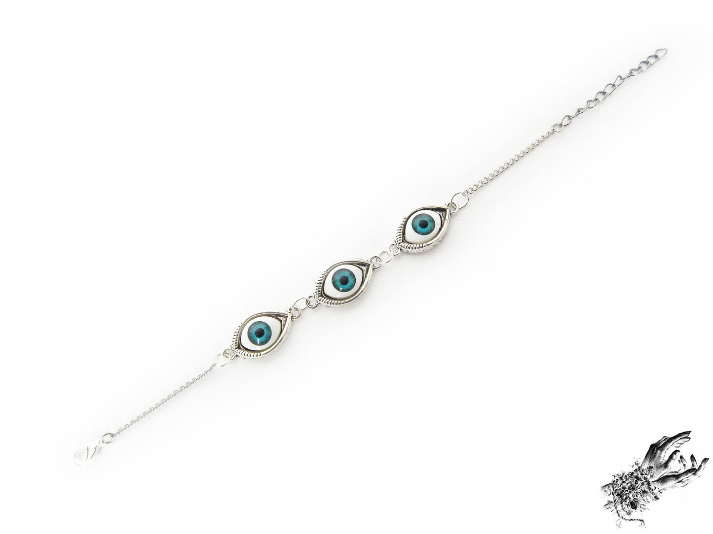 Vintage style antique silver evil eye bracelet with bright blue irises in silver plated cameo frames, displayed on a white background