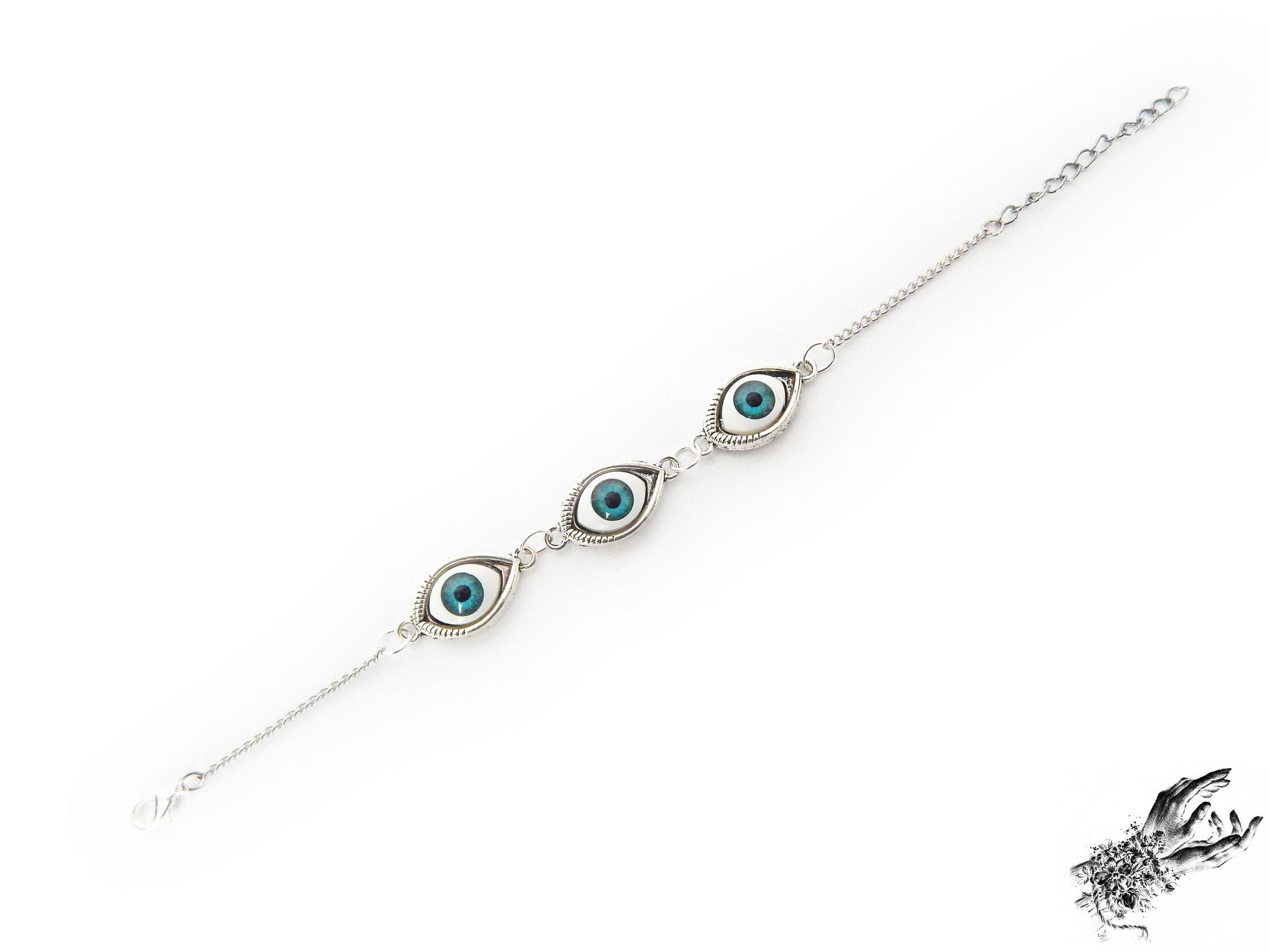 Vintage style antique silver evil eye bracelet with bright blue irises in silver plated cameo frames, displayed on a white background