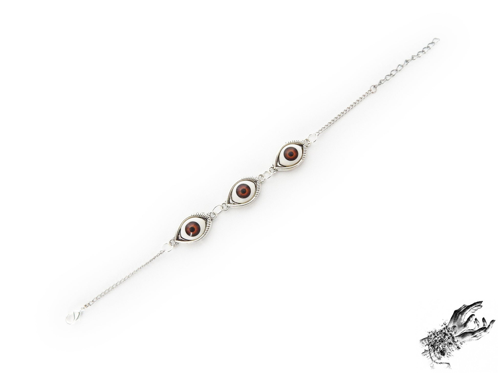 Vintage inspired antique silver evil eye bracelet showing the rich brown irises in silver cameo frames for a vintage fashion aesthetic