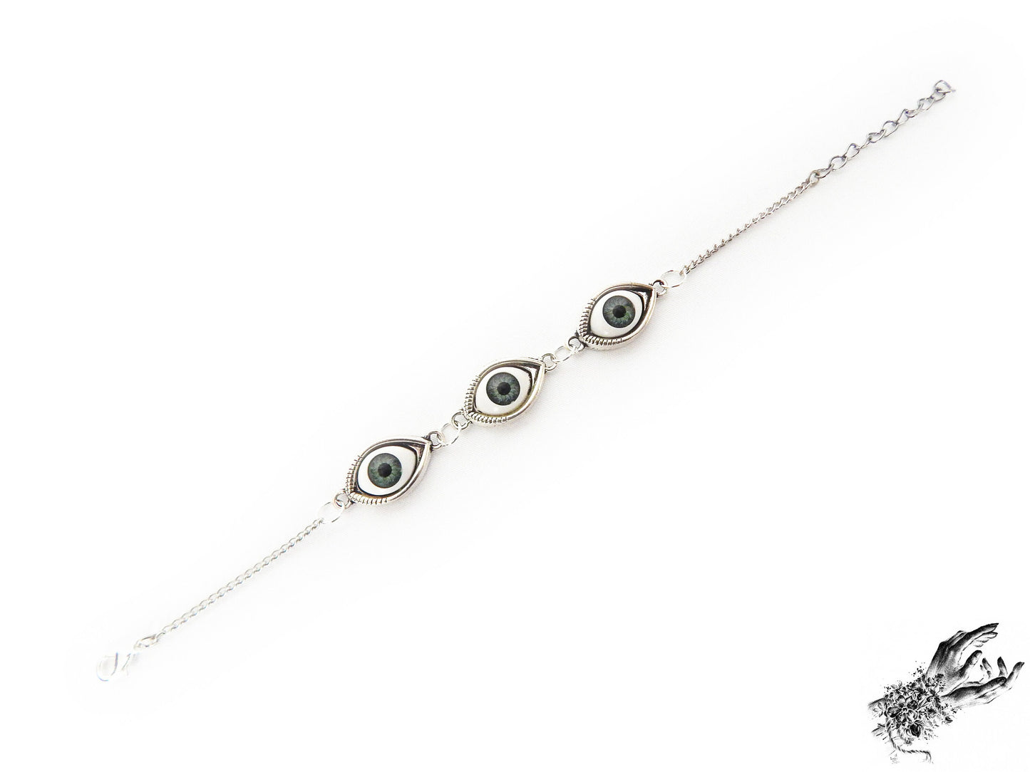 Antique silver evil eye bracelet featuring striking green irises in silver cameo frames for a vintage fashion aesthetic