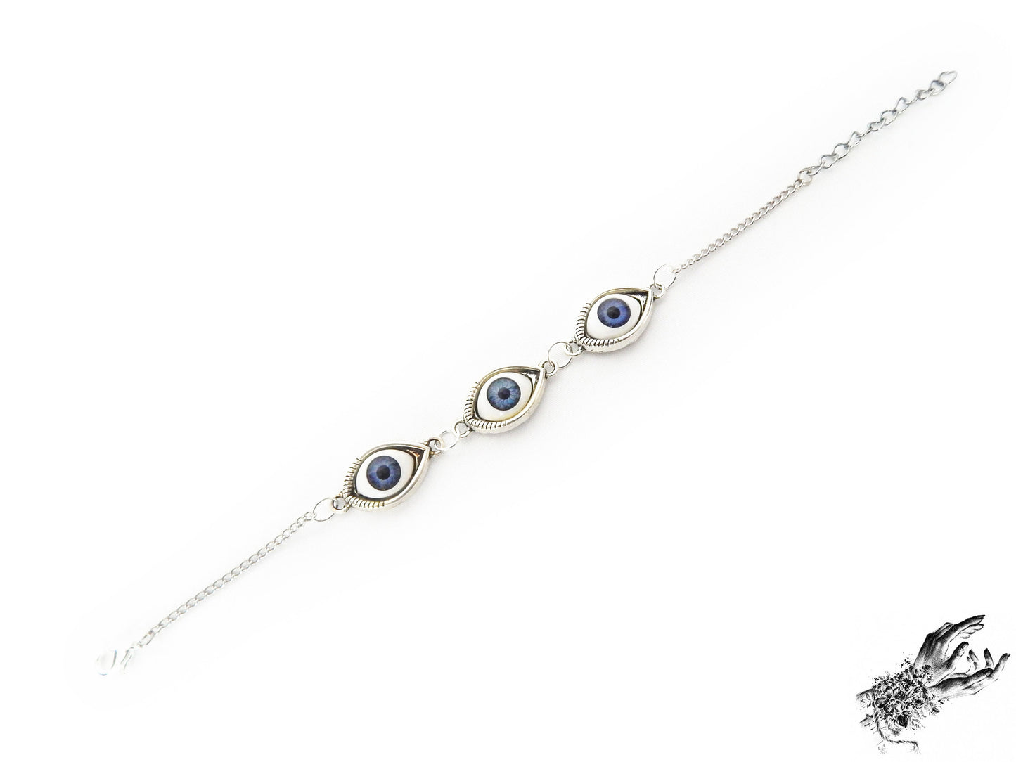 Antique silver evil eye bracelet with navy blue irises in silver cameo frames displayed on a white background and inspired by vintage fashion