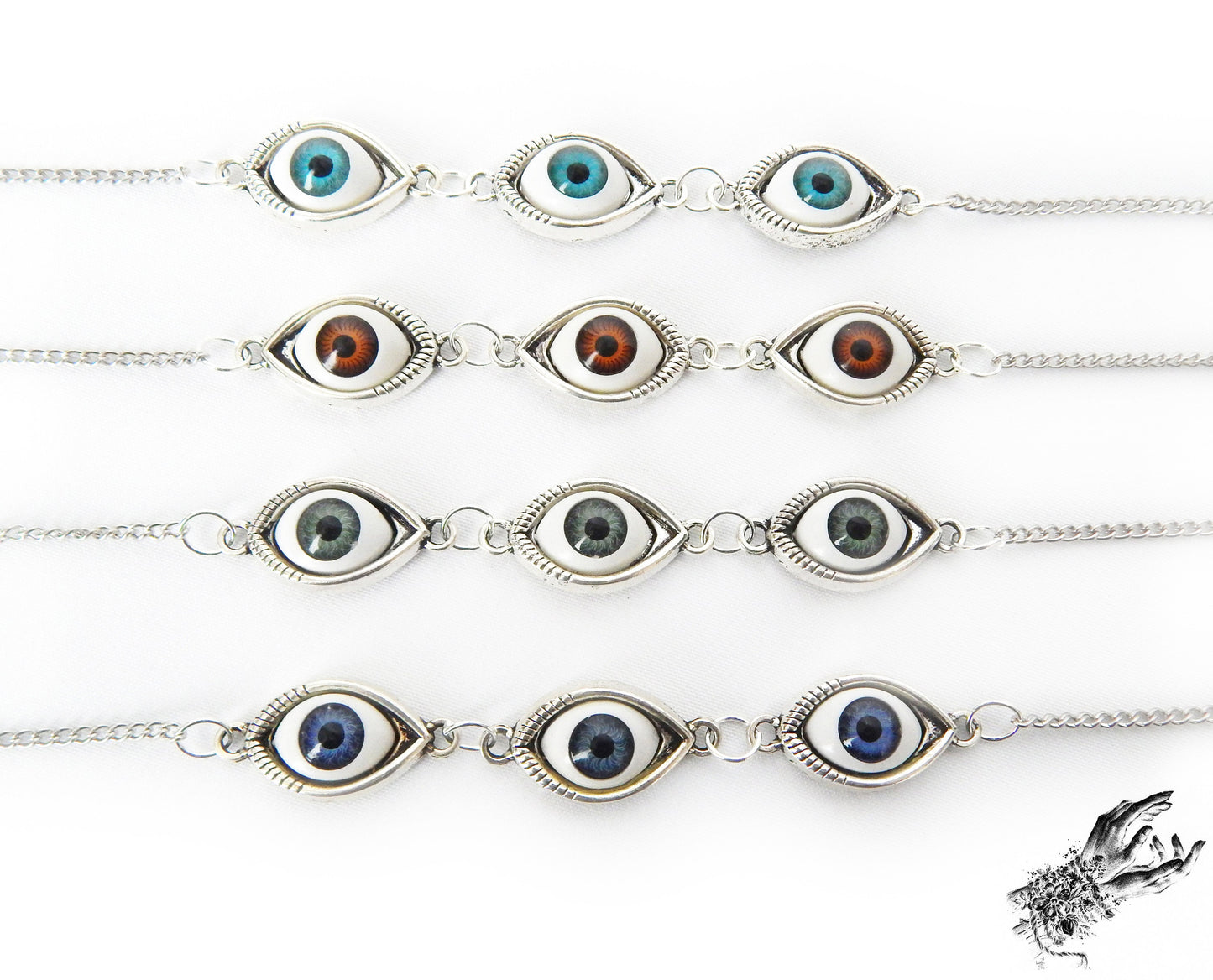Close-up of the antique bronze evil eye cameo bracelets, showing the variety of iris colours in blue, green and brown displayed on a white background