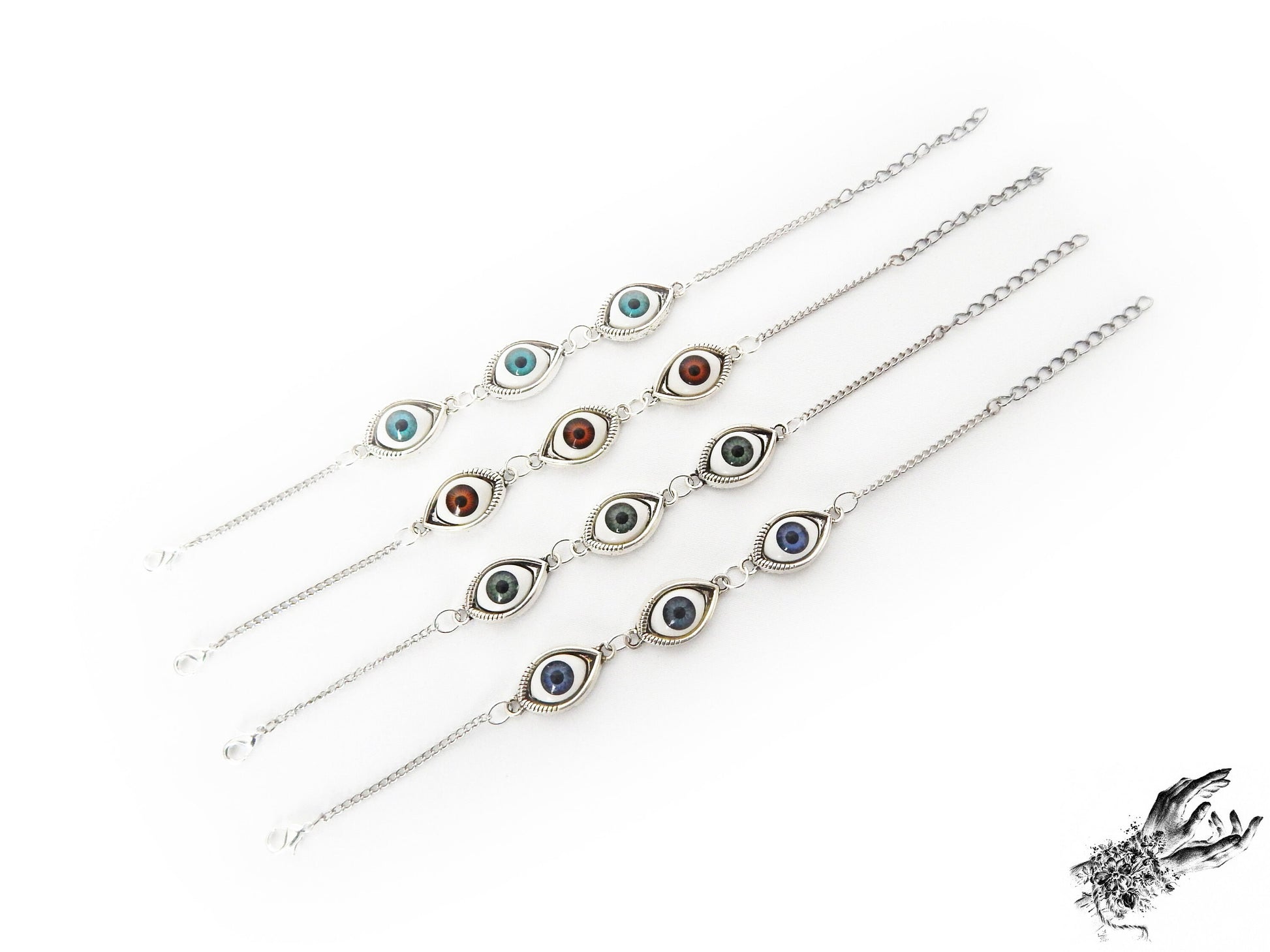 Antique style evil eye cameo bracelets featuring a variety of iris colours in blue, green and brown in silver cameo frames, displayed on a white background